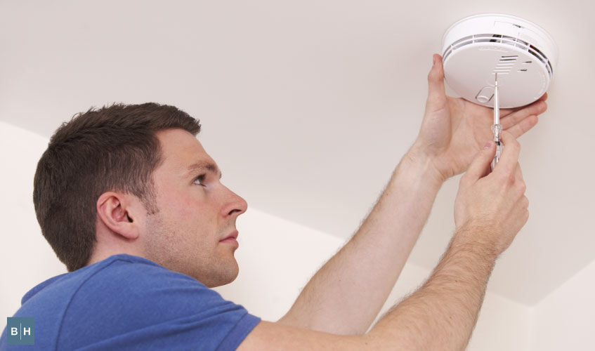 Technician inspecting fire alarm